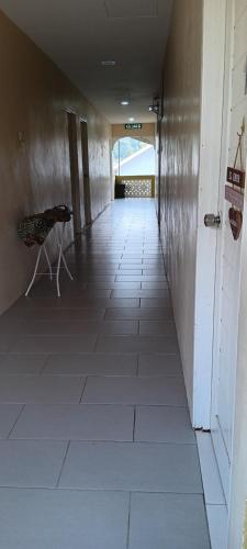 an empty hallway with a chair in a building at NURUL ROOMSTAY LANGKAWI in Pantai Cenang