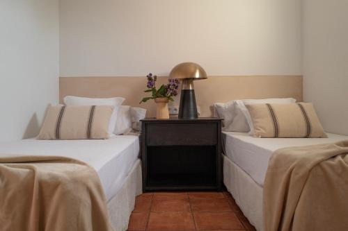 two beds sitting next to each other in a room at Can Arabí - Adults Only in Ibiza Town