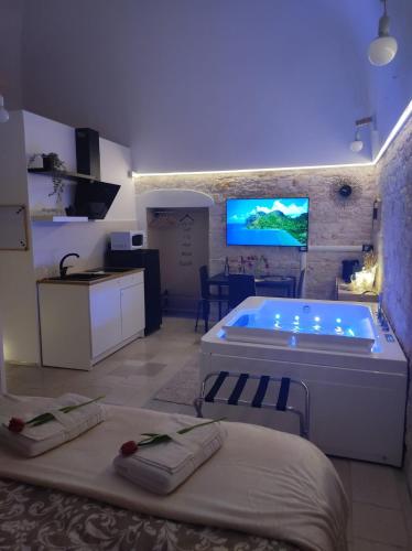 a large room with a tub and a kitchen with a kitchen at Pampa Puglia B&B in Turi