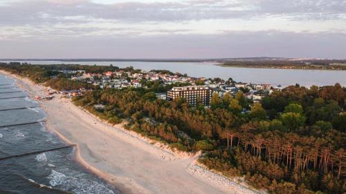 an aerial view of a beach next to the water at Instytut Zdrowia Sofra FIT & SPA in Mielno