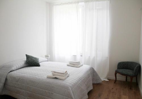 1 dormitorio con 1 cama con 2 toallas en Waterfront balcony I Grani 2 Resort Style Suite en Livorno