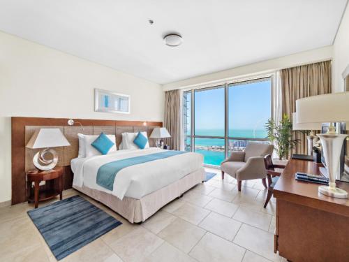 a hotel room with a bed and a desk with a desk at Blue Beach Tower The Walk JBR in Dubai