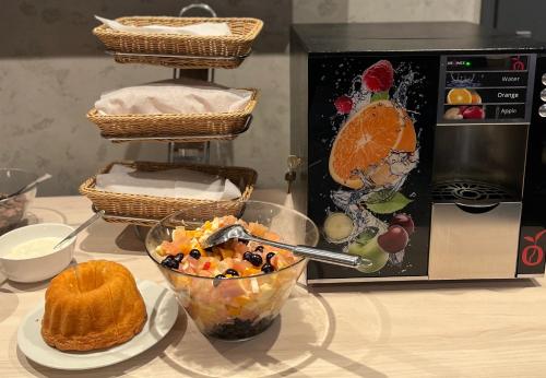 a table with a bowl of food and a microwave at Apartmány Fatrapark 1 s WELLNESSOM Hrabovská dolina in Ružomberok