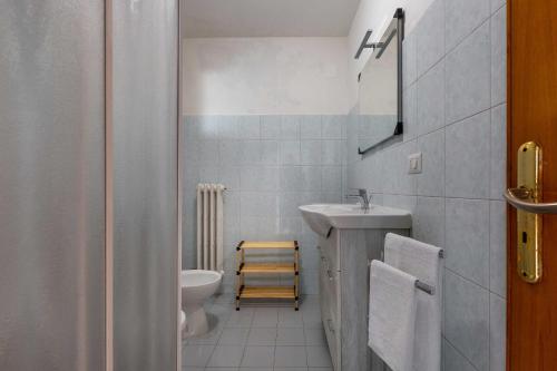 Baño blanco con lavabo y aseo en Pio Apartment by BarbarHouse, en Lecce