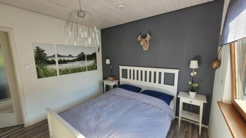 a bedroom with a bed with a blue comforter at Ferienhäuser im Feriendorf Weissensee im Allgäu F2 in Füssen