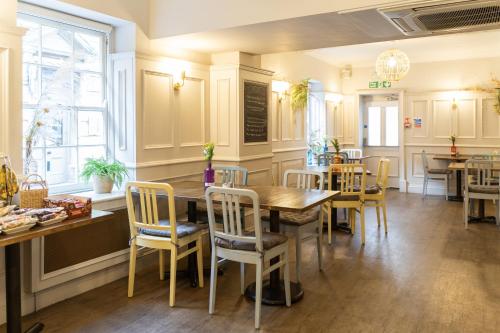 a kitchen and dining room with a table and chairs at The Red Lion Hotel in Spalding