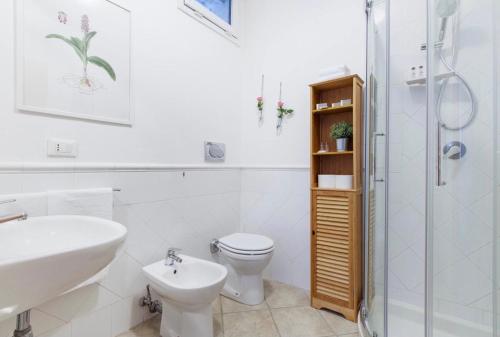 a bathroom with a toilet and a sink and a shower at Portobello Apartments in Bologna