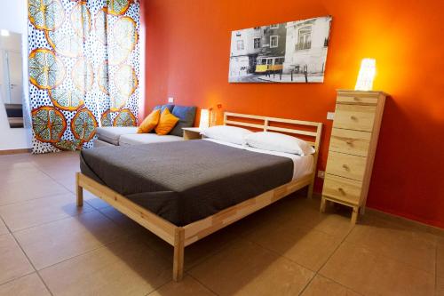 a bedroom with a bed and a couch at Guest House Parco del Mulino in Livorno