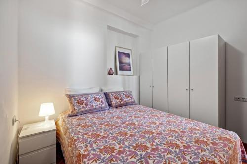 1 dormitorio pequeño con 1 cama y armario blanco en Apartamento frente a la playa, en Málaga