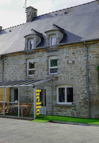 a stone building with a sign in front of it at Nawenn locations - maison du bonheur in La Landec