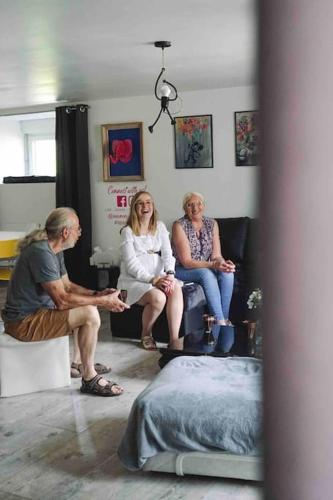 a group of three people sitting in a room at Nawenn locations - maison du bonheur in La Landec