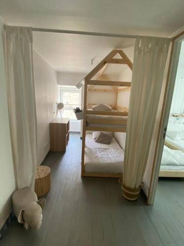 a bedroom with two bunk beds and a mirror at Nawenn locations - maison du bonheur in La Landec