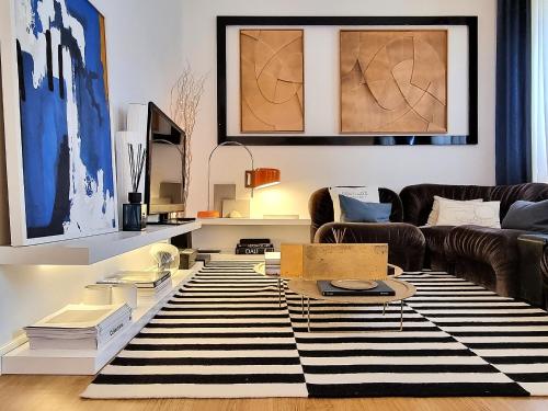 a living room with a black and white rug at NEW - Epic Design -AC, Balcony, Free Parking in Linda-a-Velha