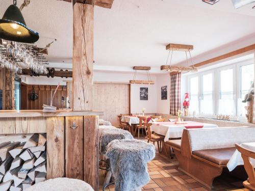 a restaurant with wooden walls and tables and chairs at Xeis NeSt in Admont