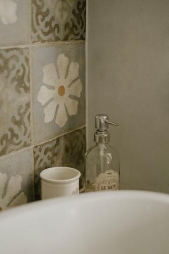 a bottle of soap sitting on top of a bathroom sink at Belcasale in Vignale Monferrato