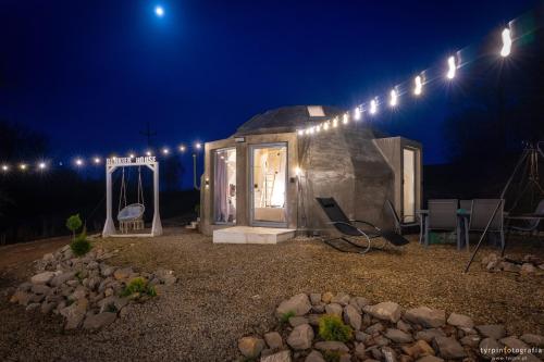 a small home with a lit up door at night at Bunkier House in Niedźwiada