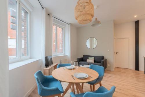 a living room with a table and chairs and a couch at One bedroom apartment with parking, city center in Tourcoing