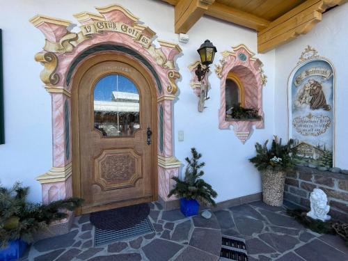 an entrance to a building with a wooden door at Ferienwohnung "Beim Henser" in Wallgau