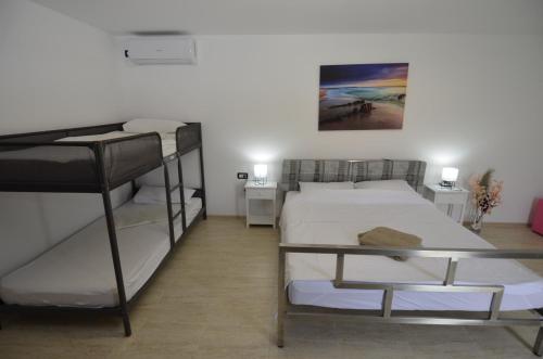 a room with two bunk beds and a table at Vila La Panda in Costinesti