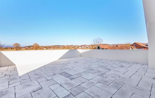 a room with a white wall and a tile floor at 6 Bedroom Stunning Home In Podgrade in Tugonica