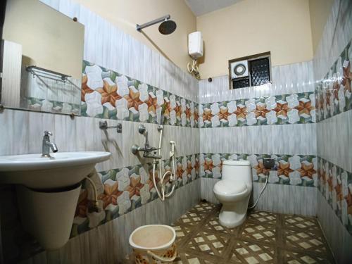 a bathroom with a toilet and a sink at The Sea Horse in Mandarmoni