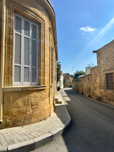 a brick building with a window on the side of a street at MARTIN Nicosia City Suites in Nicosia
