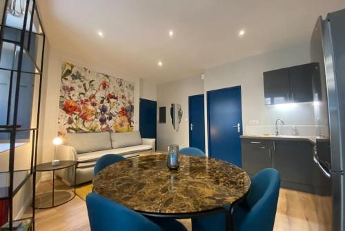 une cuisine et un salon avec une table et des chaises dans l'établissement Cocon des Chandeliers, à Bordeaux