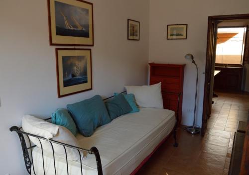 a couch with pillows on it in a room at STELLA HOUSE in Porto Santo Stefano