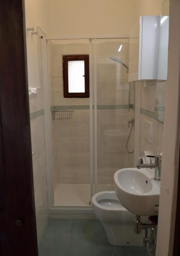 a bathroom with a shower and a toilet and a sink at STELLA HOUSE in Porto Santo Stefano