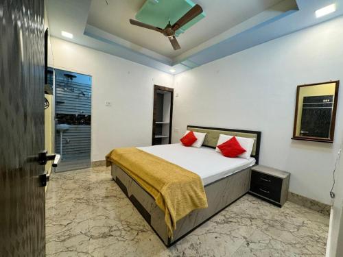 a bedroom with a bed with red pillows at Hotel Nalanda Inn Bihar in Nalanda