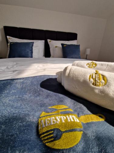 a bedroom with a bed with a baseball rug on it at Apartmani Leburic in Prnjavor