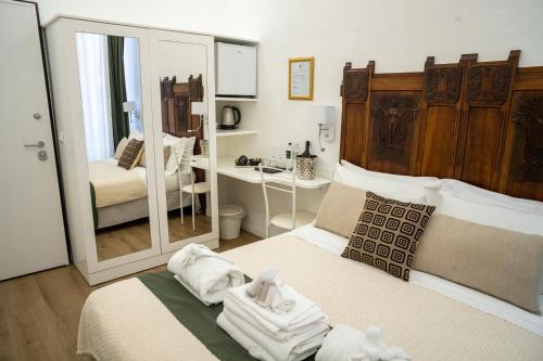 a bedroom with two beds and a mirror at Vittorio Veneto Private SPA in Sulmona