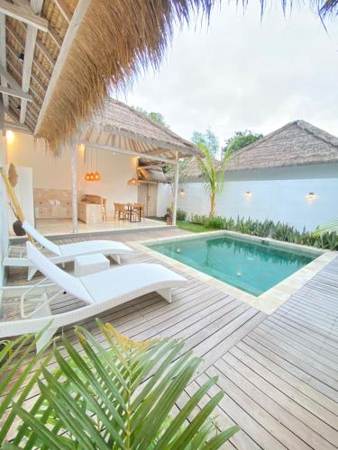 a villa with a swimming pool and a patio at Mimpi Villa - Gili Air in Gili Islands