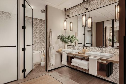 a bathroom with two sinks and a large mirror at One&Only One Za'abeel in Dubai