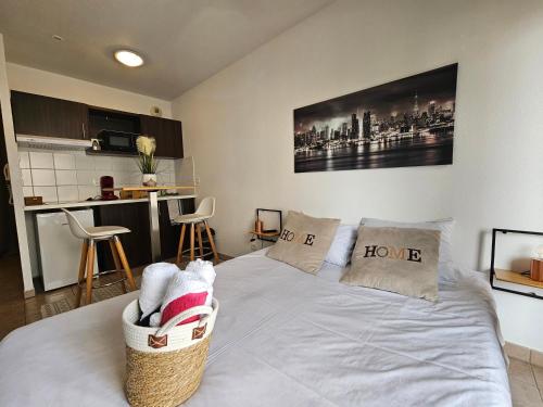 Cet appartement comprend une chambre avec un lit blanc et une cuisine. dans l'établissement A116 Appartement disneyland Paris T1, à Montévrain