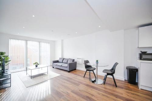 a living room with a couch and a table at Modern 1Bed Apt with Parking - Grand Exchange Bracknell in Bracknell