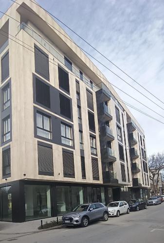 a large building with cars parked in front of it at RB Apartment 3 Lux smart house in Subotica