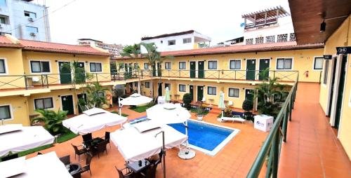 a balcony view of a hotel with a swimming pool at Fortaleza Guesthouse in Luanda