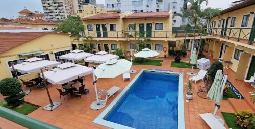 an overhead view of a swimming pool with umbrellas at Fortaleza Guesthouse in Luanda