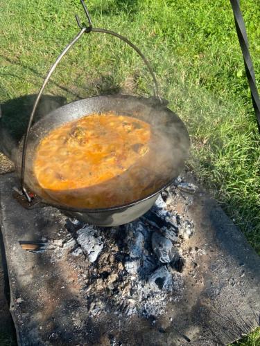 a pot sitting on top of a grill at Casa Cataleya in Bucşoaia