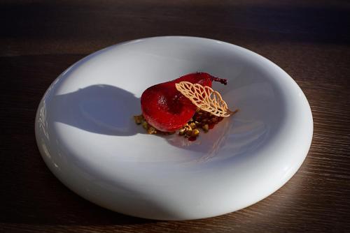 a white plate with a dessert on a table at Paradiso Pure Living Vegan Hotel in Alpe di Siusi