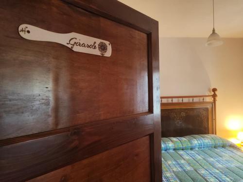 a bedroom with a bed and a wooden headboard at Agriturismo Podere Fiume in Pratovecchio