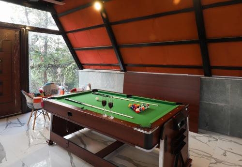 a room with a pool table in a room at ELIVAAS 3 BHK with Treehouse & Pvt Pool - Handa's Gateway in Dhauj
