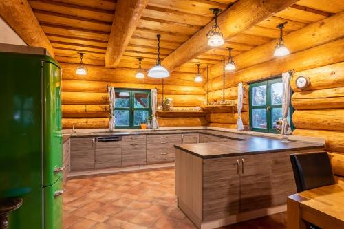 a kitchen in a log cabin with a refrigerator at Srub Pohodář v Novohradských horách in Benešov nad Černou