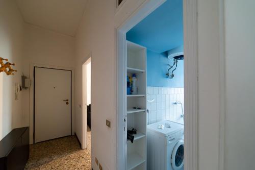 a bathroom with a washer and dryer in a room at Hbhall Residenze Darsena in Milan