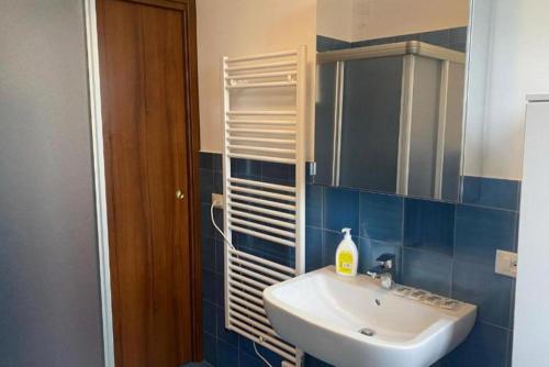 a bathroom with a sink and a mirror at Residenza Cipressi e Olivi in Verona