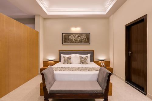 a bedroom with a bed and a chair at Lemon Tree Resort, Kumbhalgarh in Kumbhalgarh