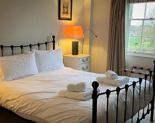 a bedroom with a large bed with towels on it at The Bedingfeld Arms in Swaffham