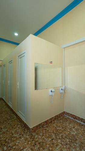 a bathroom with a mirror and a wall with toilets at Hostel Mandaria in Kutaisi