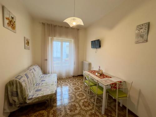 a living room with a table and a couch at L'OLIVO DI EVELINA in Bagnoregio